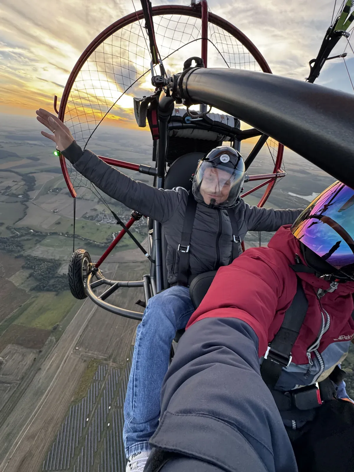 Pasażer macha ręką podczas lotu motoparalotnią